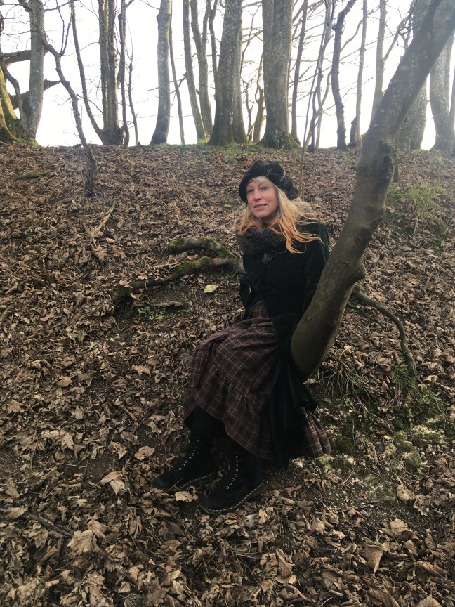Picture of woman with long hair in a woodland with a tree
